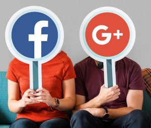 A woman and man holding facebook and google Logol